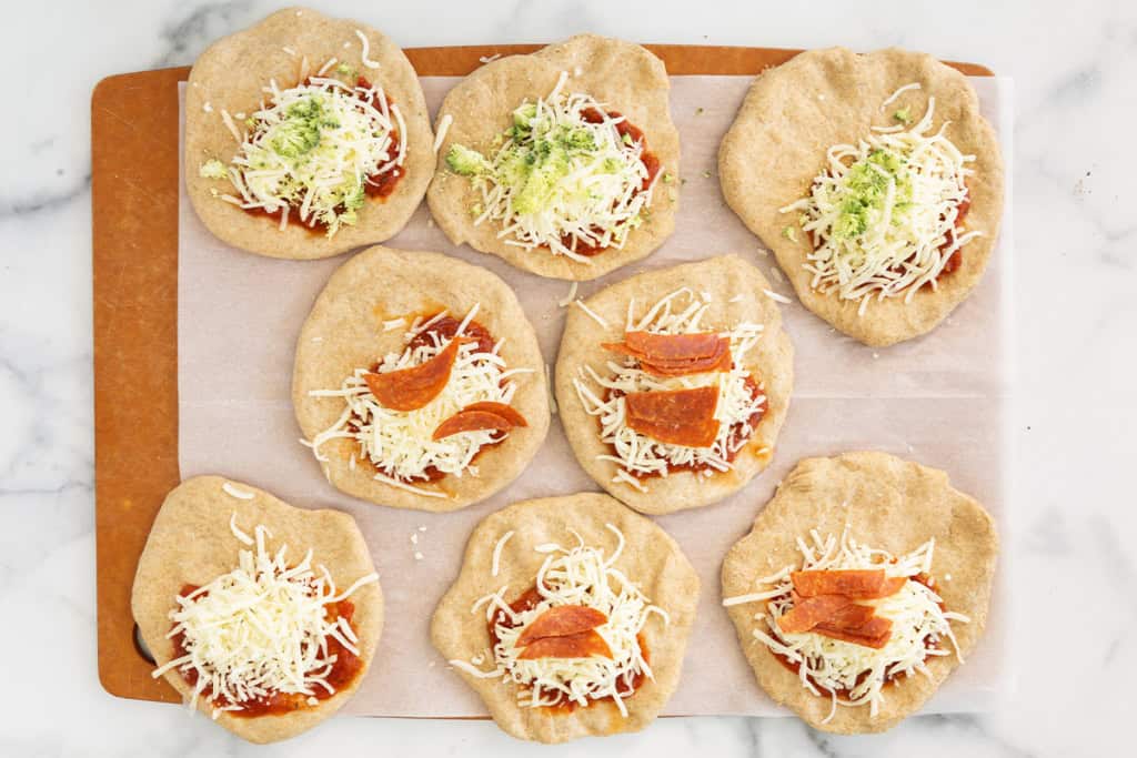 Dough circles with filling on top for pizza pockets.