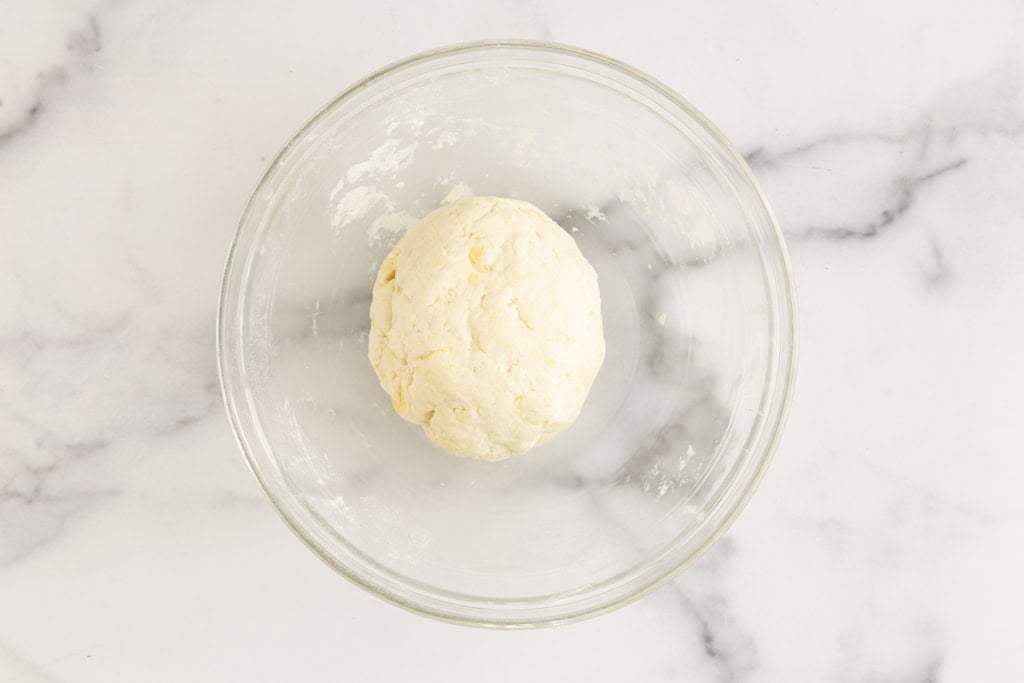 Yogurt flatbread dough in glass bowl.