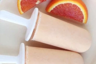 creamsicles on white plate with orange slices.