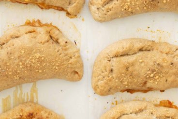 Pizza pockets on baking sheet.