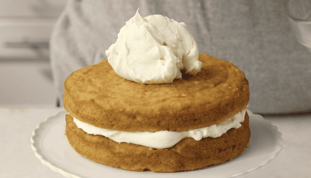 Topping sweet potato baby cake with cream cheese frosting.