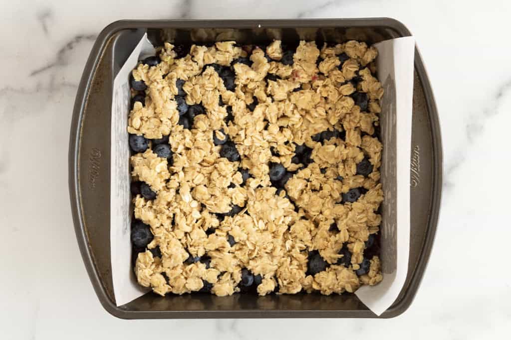 Blueberry oatmeal bars in baking pan before baking.