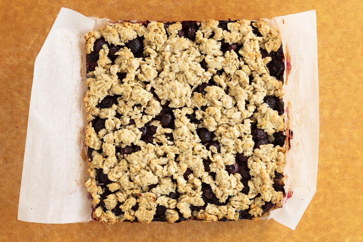 Blueberry oatmeal bars on cutting board.