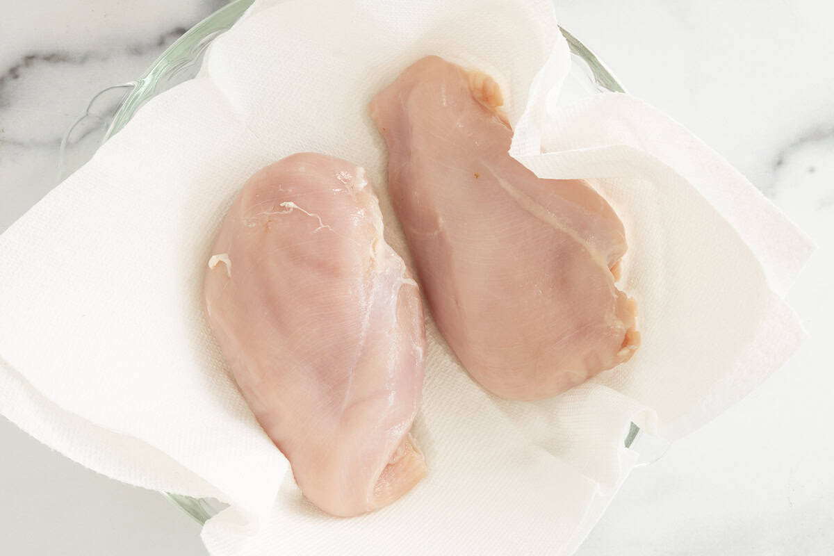 Chicken breasts on paper towel for chicken bites.