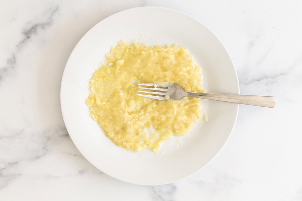 Banana mashed with a fork for healthy granola bars.