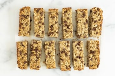 Healthy granola bars cut into bars on countertop.