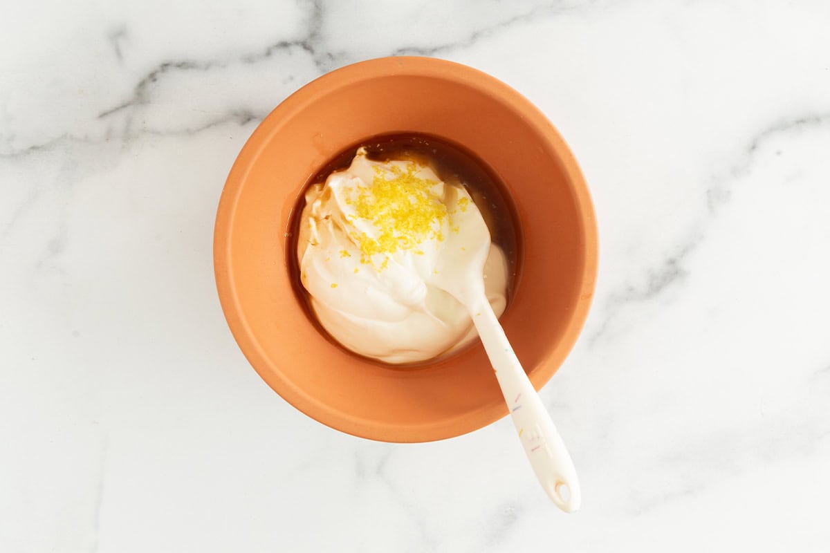 Ingredients for lemon yogurt in mixing bowl before mixing.