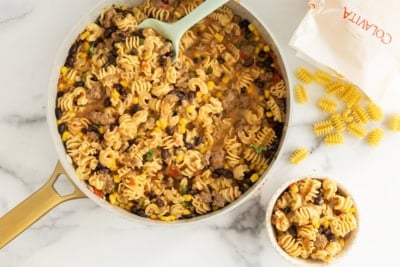 Pan and bowl of taco pasta.