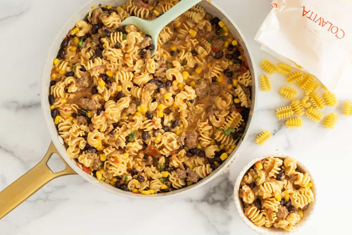 Pan and bowl of taco pasta. 