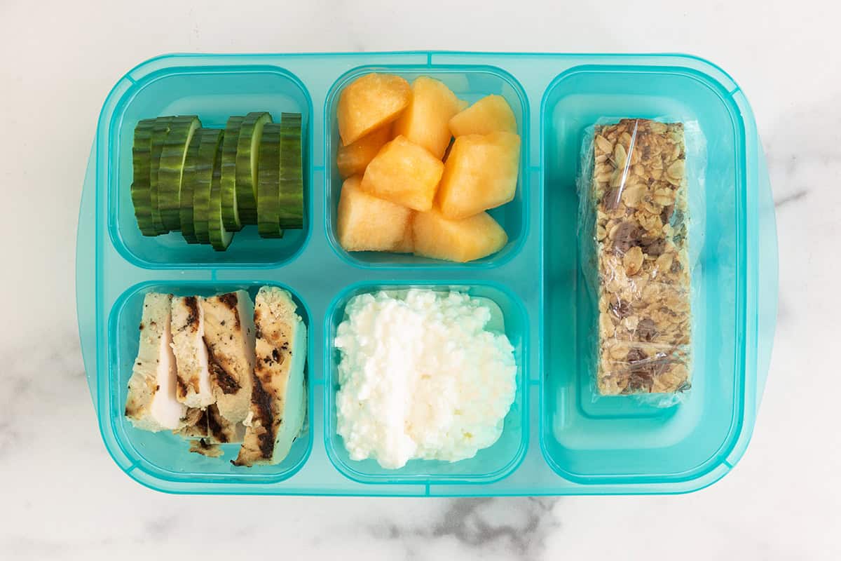 Lunchbox with cottage cheese, fruits, veggies and chicken.