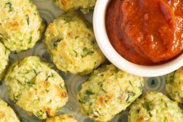 Zucchini tots on plate with ketchup.