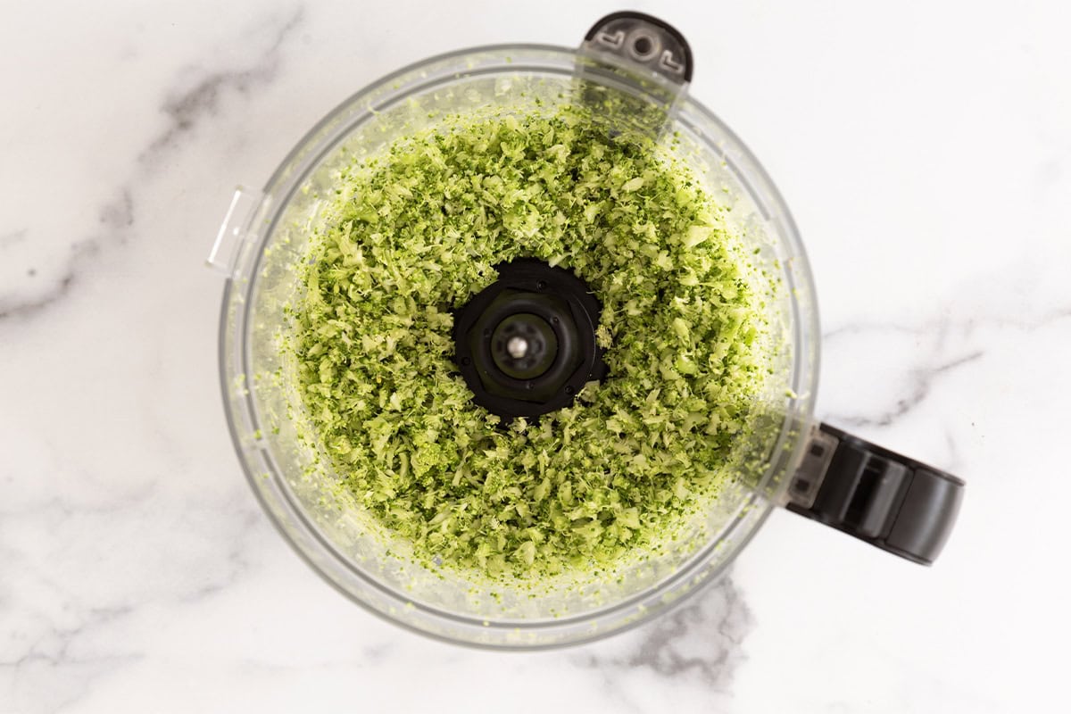 Broccoli chopped up in food processor for broccoli rice.