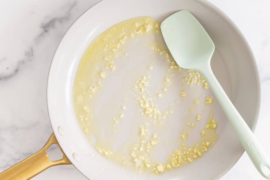 Garlic and oil in pan for broccoli rice.