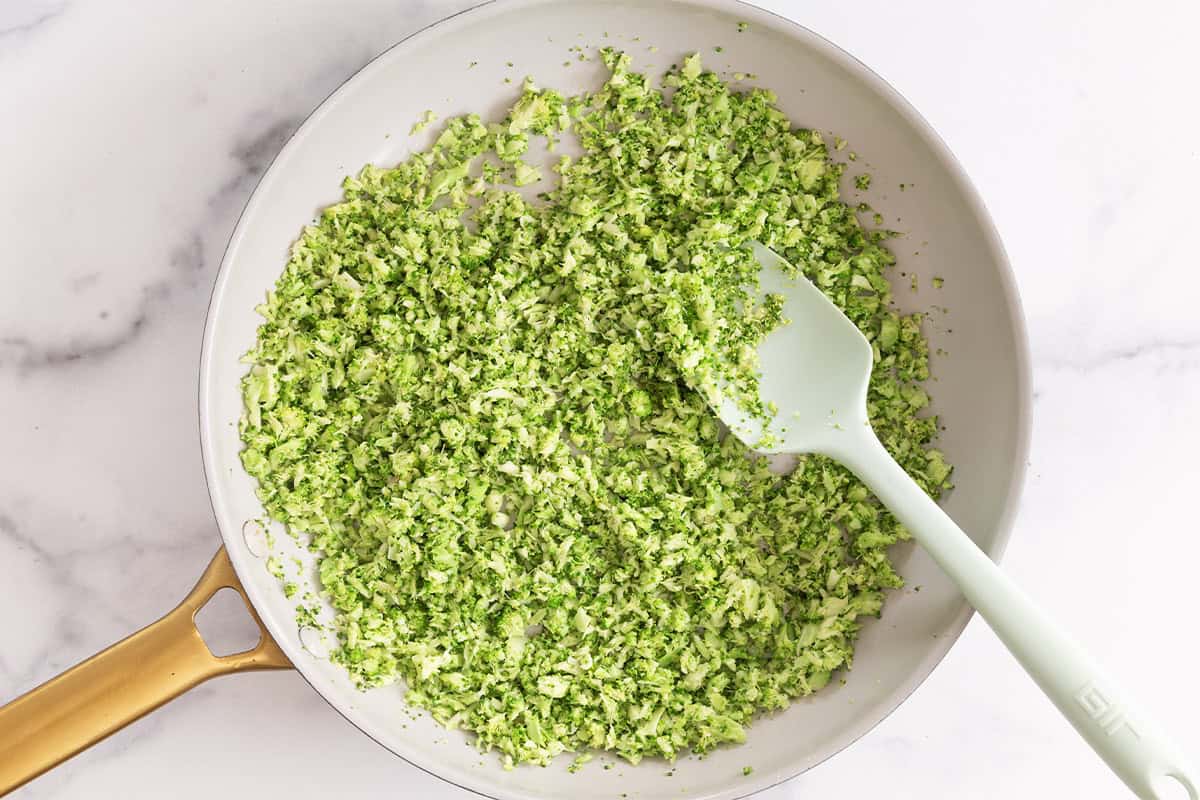 Broccoli in pan with spatula for broccoli rice.