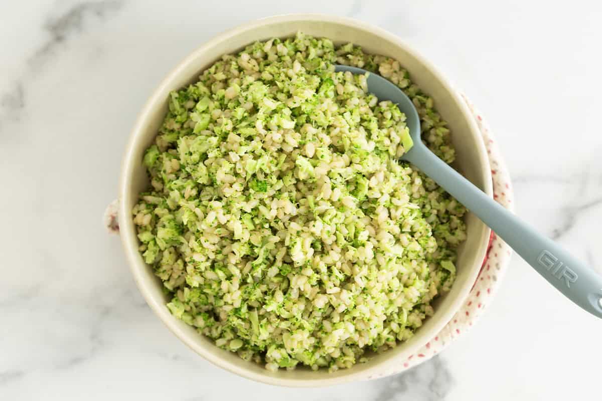 Broccoli rice in bowl with spoon.