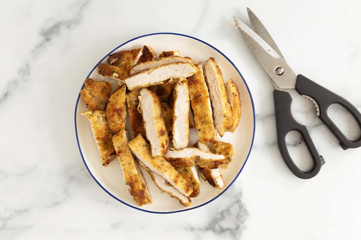 Chicken cut into strips for chicken caesar pasta salad.