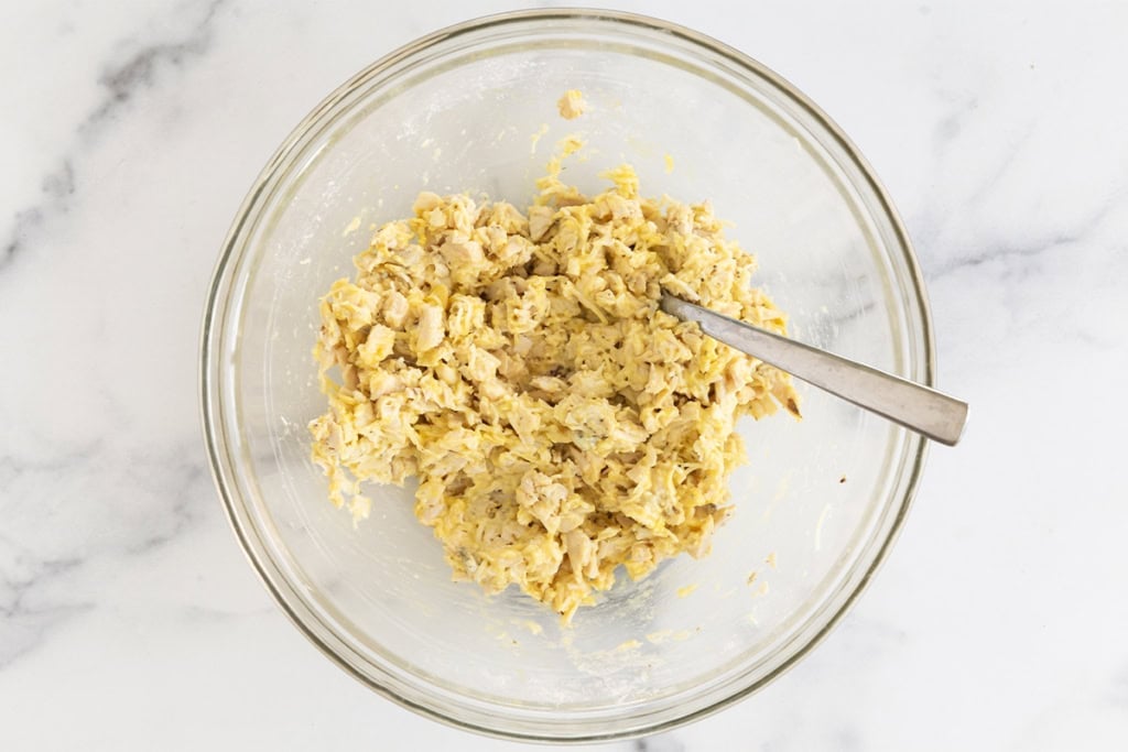 Mixture for chicken fritters in glass bowl.