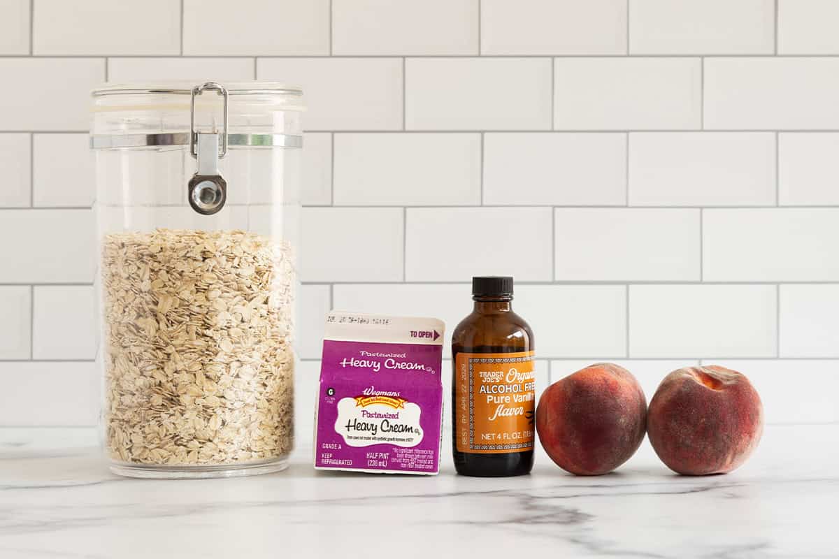 Ingredients for peaches and cream oatmeal on countertop.