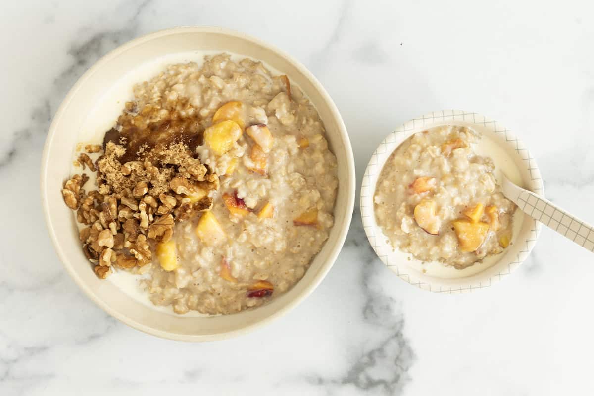 Peaches and cream oatmeal in two bowls.