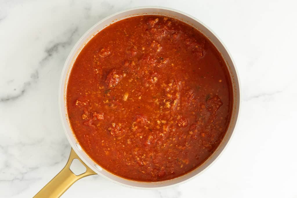 Tomato sauce with beef in skillet for skillet lasagna.