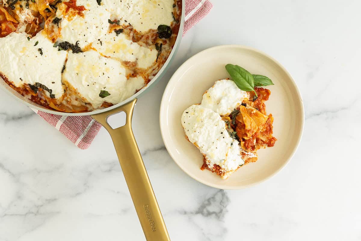 Skillet lasagna in pan and on white plate.