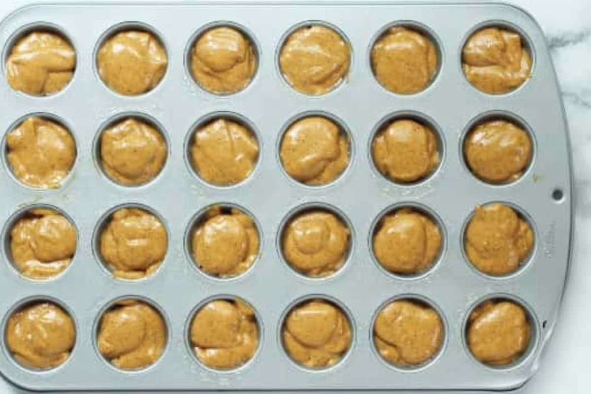 Pumpkin muffins in mini muffin pan before baking.