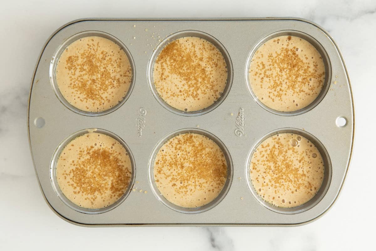 Apple oatmeal muffins in muffin pan before baking.