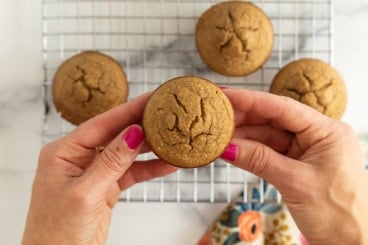 Apple oatmeal muffins in hands.