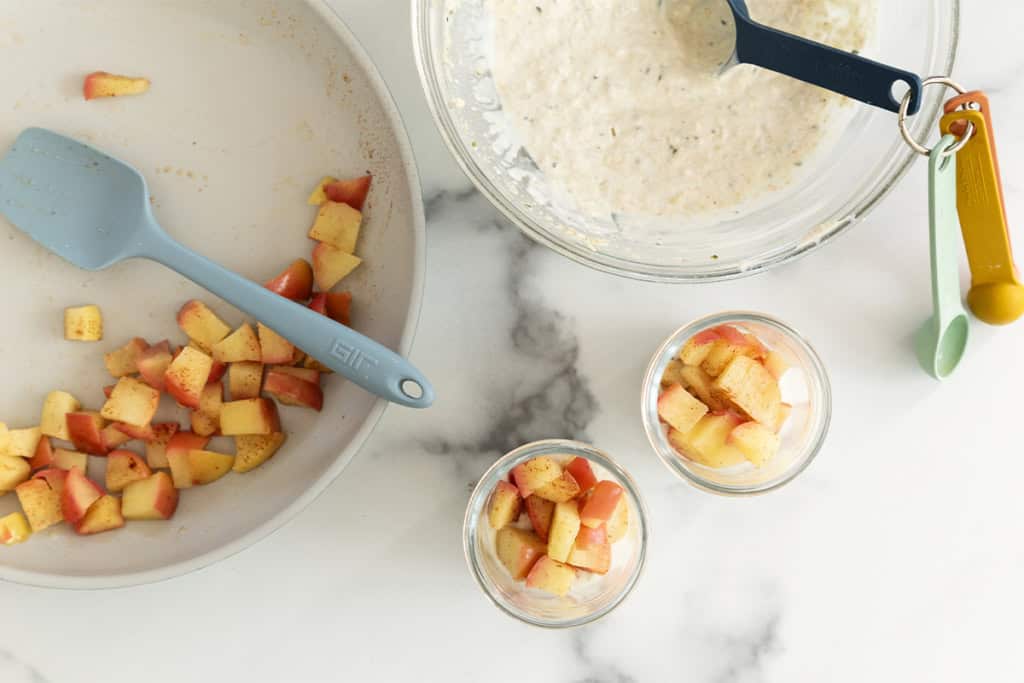 Making apple overnight oats in glass jars.