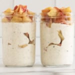 Apple overnight oats in two glass jars.