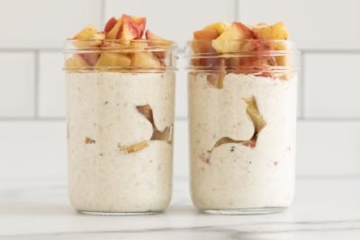 Apple overnight oats in two glass jars.