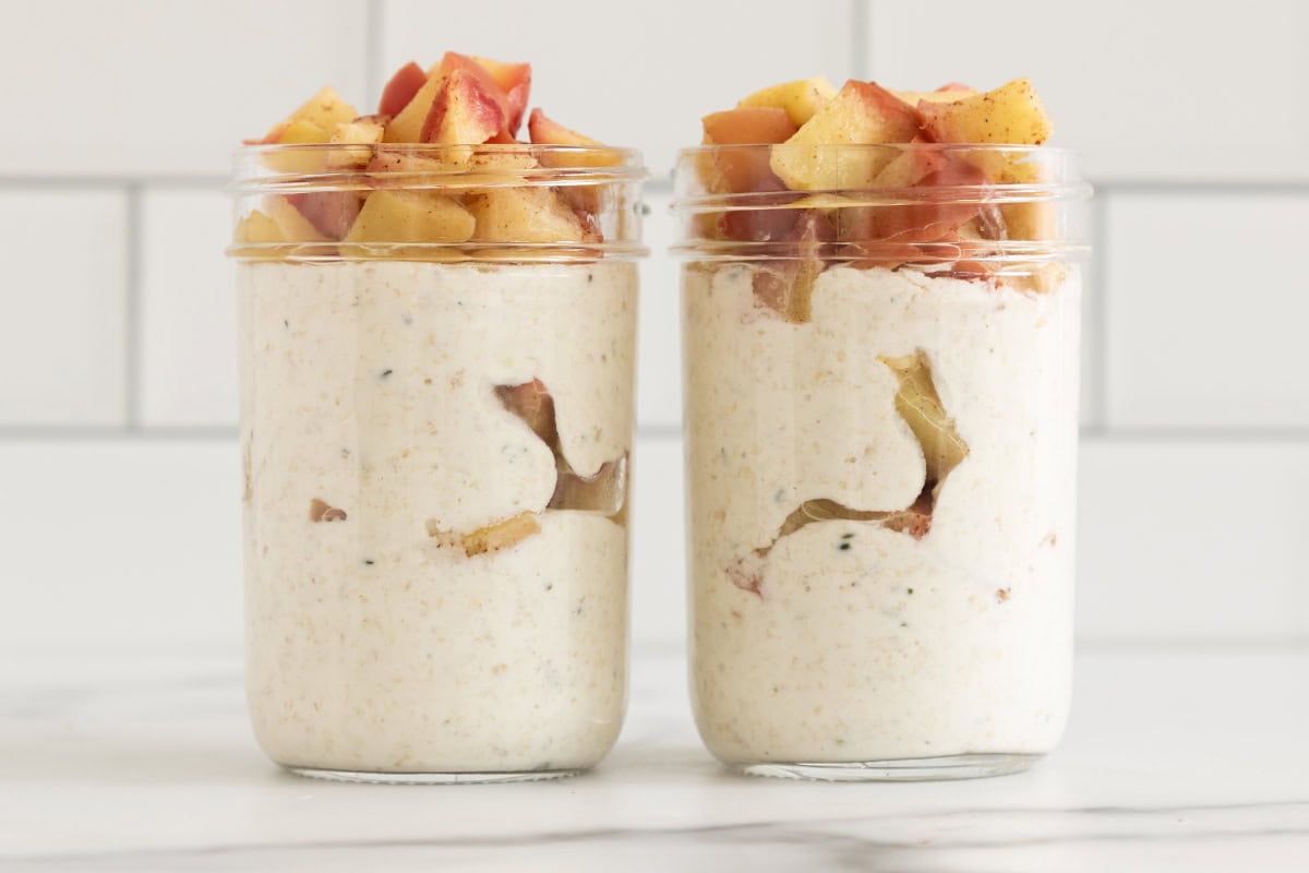 Apple overnight oats in two glass jars. 