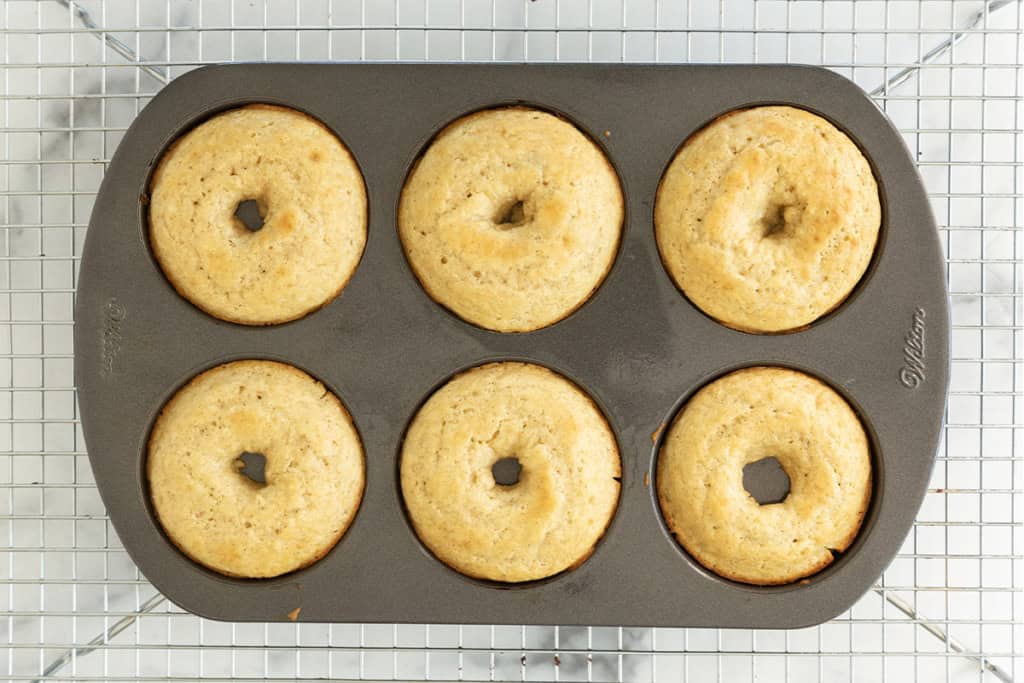 Baked donuts in donut pan after baking.