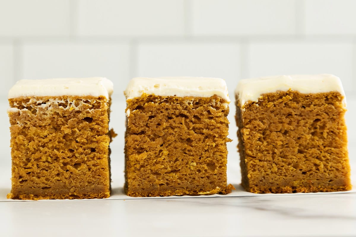 Squares of pumpkin cake on countertop.