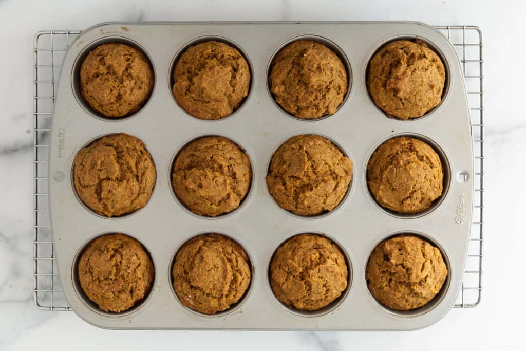 Pumpkin banana muffins in muffin pan after baking.