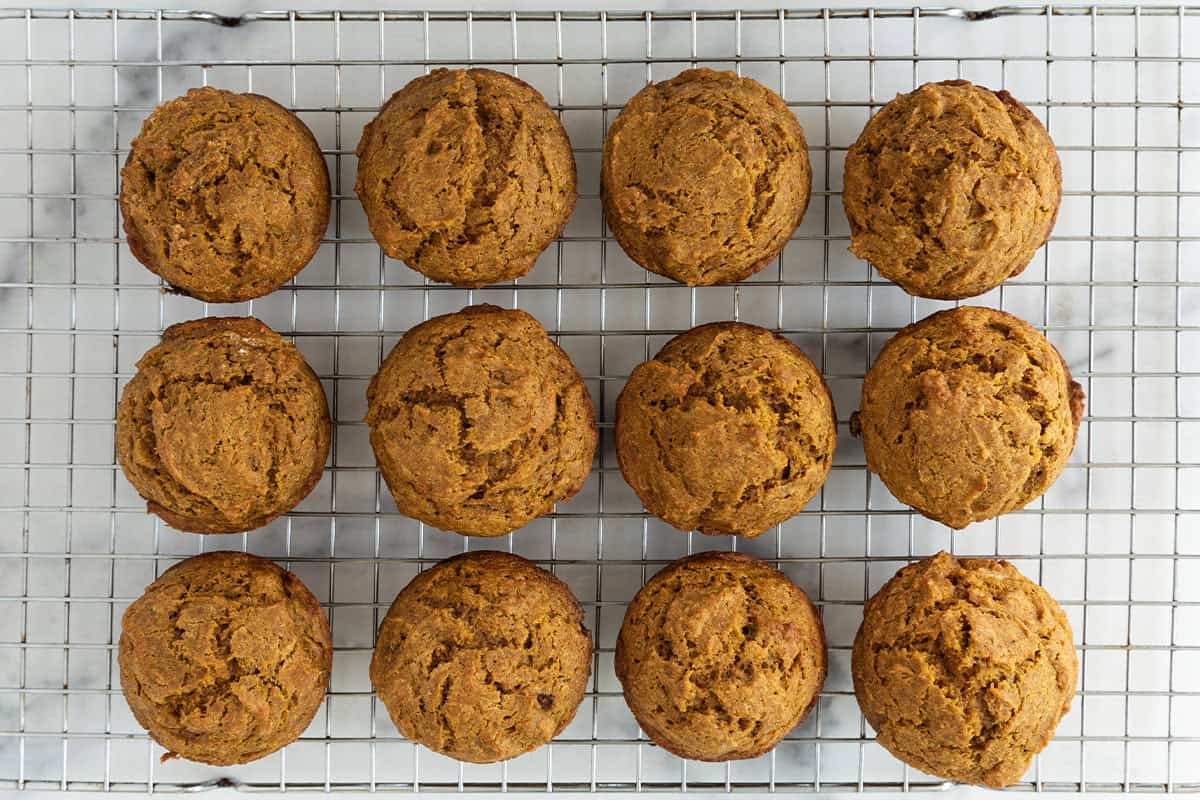 Pumpkin banana muffins on cooling rack.