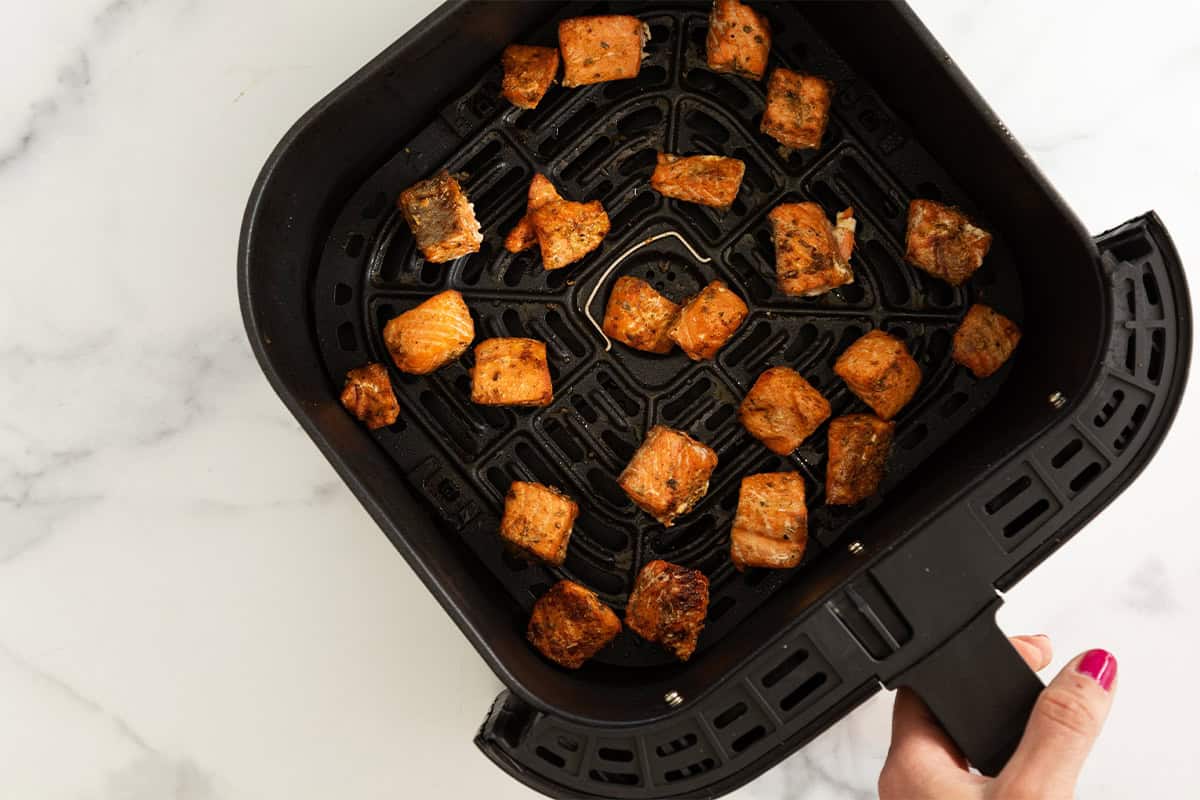 Salmon bites in air fryer before cooking.