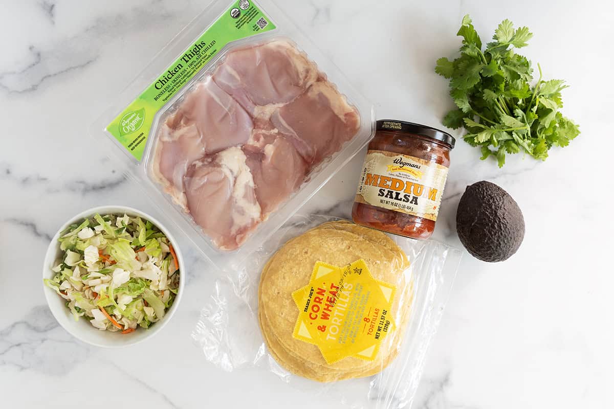 Ingredients for salsa chicken tacos on countertop.