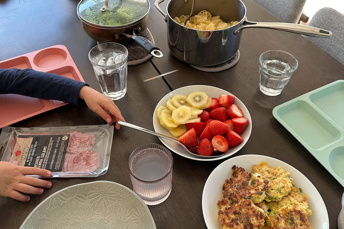 family dinner on table with child arm.