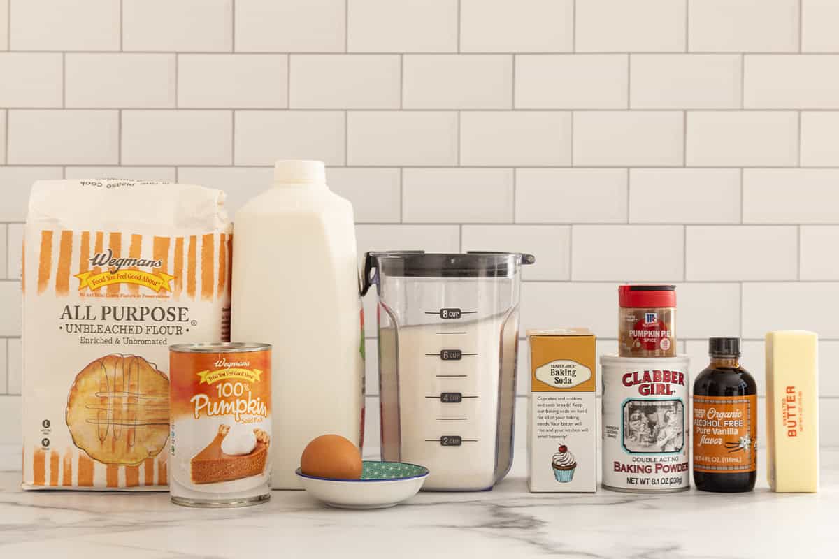 Ingredients for baked pumpkin donuts on countertop.