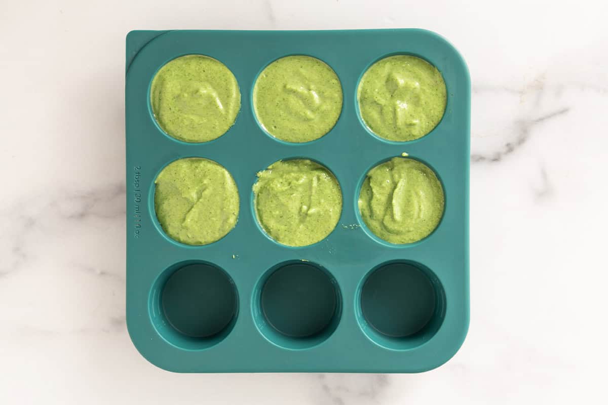 Green pasta sauce in silicone freezer container.