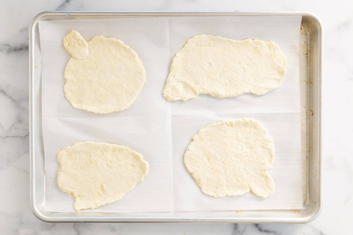 Halloween pizza dough spread on baking sheet.