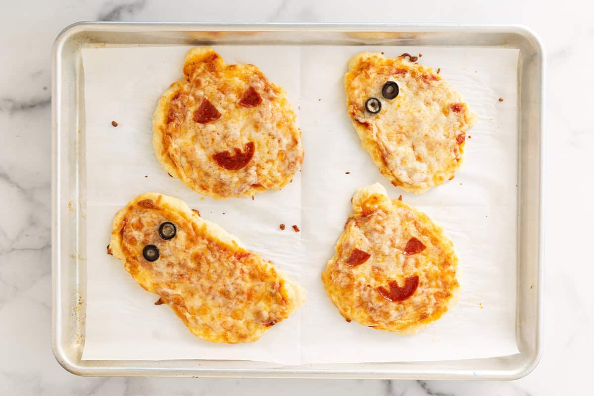 Halloween pizzas on baking sheet after baking.