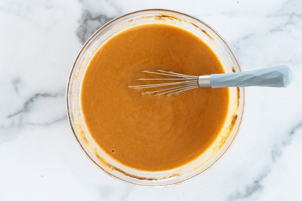 Batter for mini pumpkin pies in glass bowl.