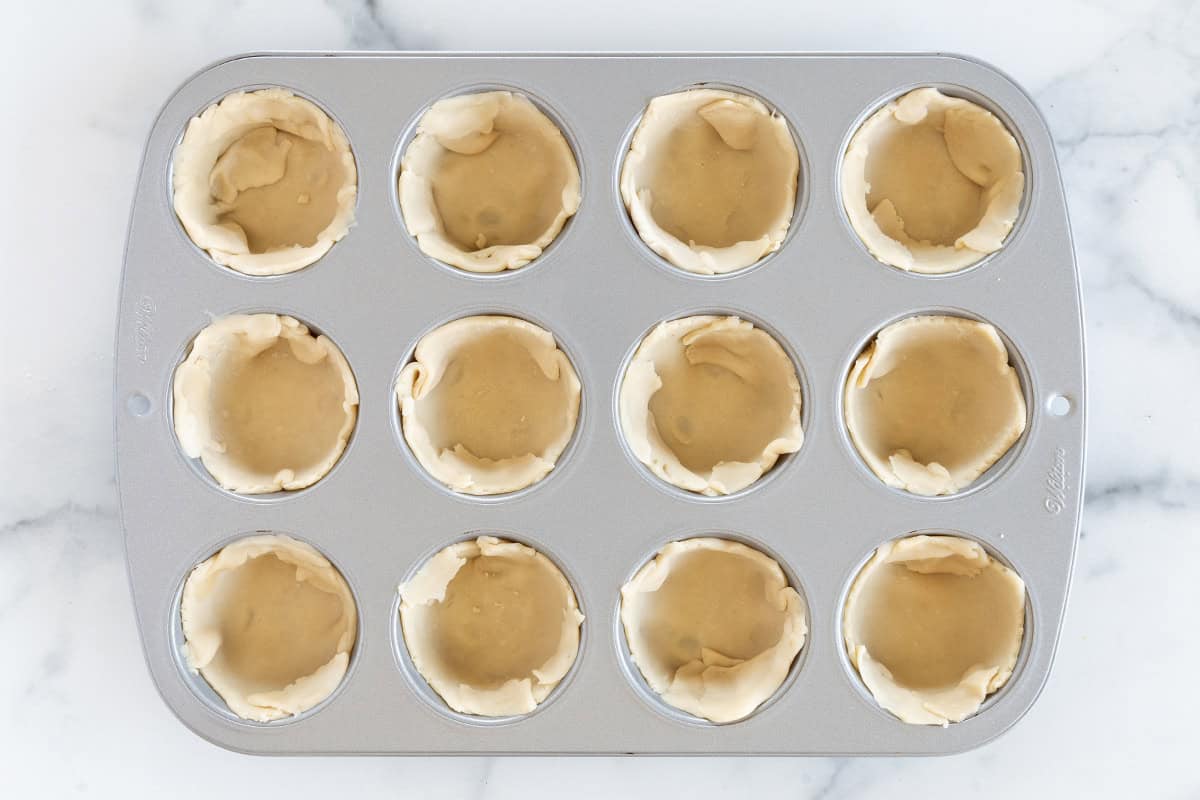 Pie crust in muffin pan for mini pumpkin pies.