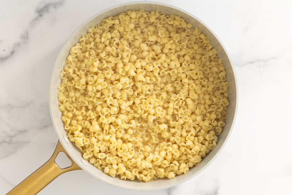 Noodles in pan for one pot mac and cheese.