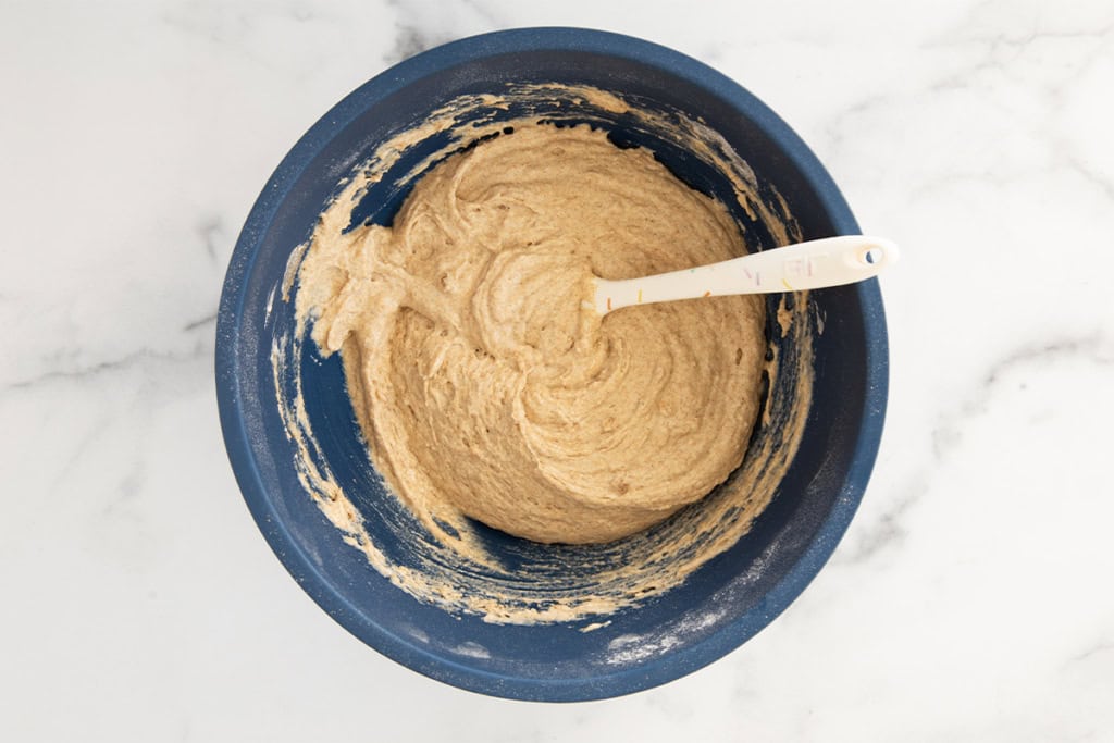 Wet ingredients for pear muffins in blue bowl.