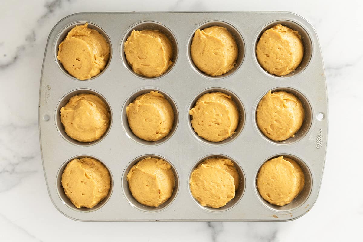 Pumpkin protein muffins in muffin pan before baking.