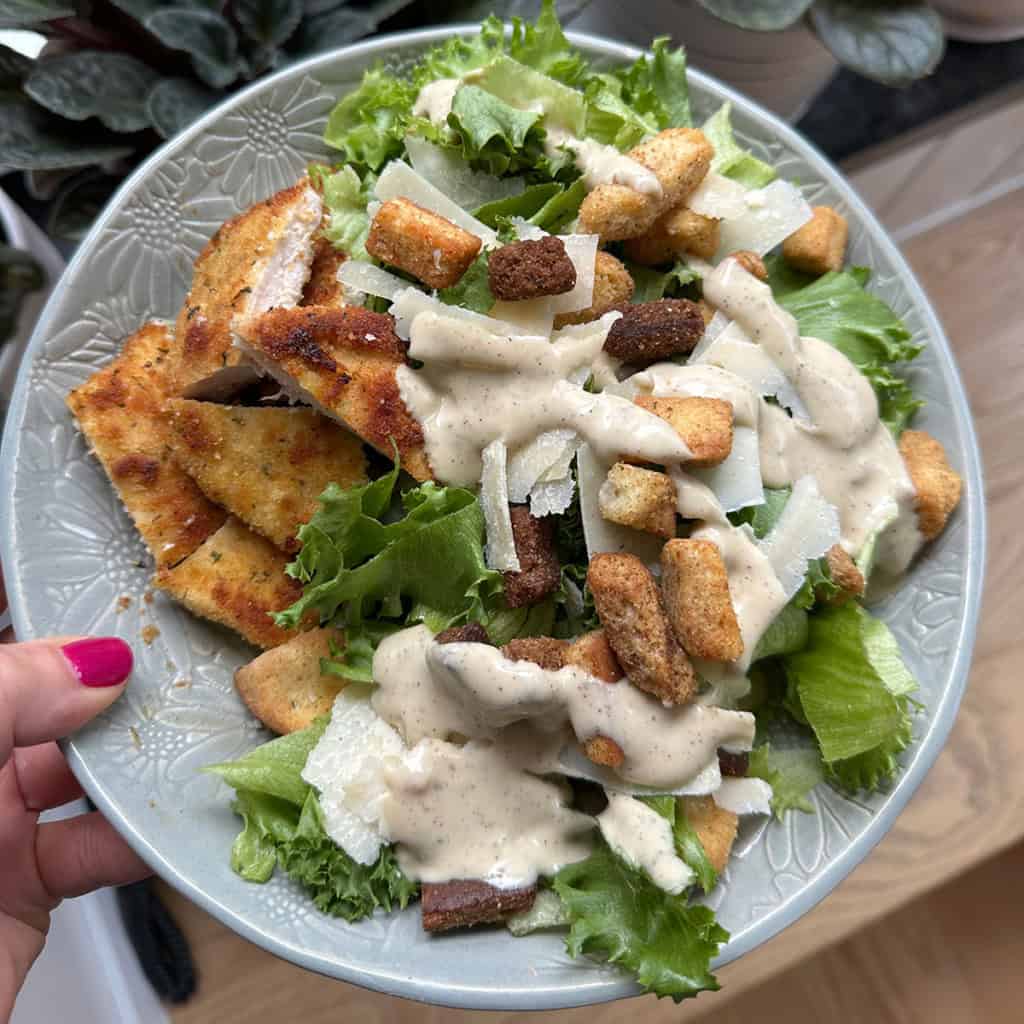 chicken caesar salad on gray plate.