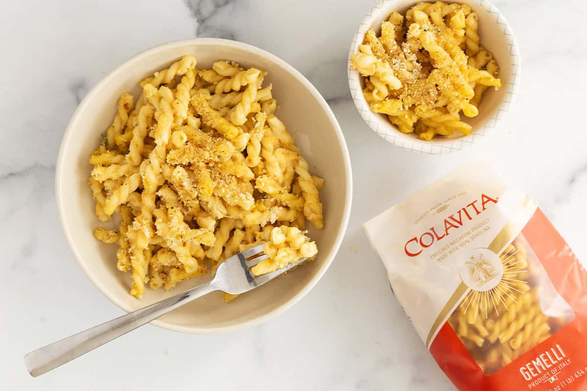 two bowls of butternut squash pasta bake on counter.